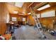 The workshop's interior featuring a ladder, wood-paneled walls, a ceiling, and an open layout at 3076 Harris Mill Ct, Duluth, GA 30096