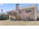 Expansive backyard featuring a deck with stairs and a blossoming tree at 407 Black Fox Dr, Locust Grove, GA 30248