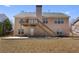 Exterior view of the backyard showcasing a wooden deck with stairs and a patio at 407 Black Fox Dr, Locust Grove, GA 30248