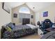 Bedroom featuring neutral walls, vaulted ceiling, window, and game-themed decor at 407 Black Fox Dr, Locust Grove, GA 30248