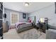 Bedroom with gray walls, light carpet, stylish bed, and an accent Chanel wall decor at 407 Black Fox Dr, Locust Grove, GA 30248