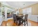 Formal dining room with wood floors, modern chandelier, with gray chairs and white molding at 407 Black Fox Dr, Locust Grove, GA 30248