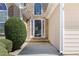 Close-up of the front door with decorative stone accents and manicured landscaping at 407 Black Fox Dr, Locust Grove, GA 30248
