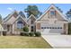 Charming home with a well-manicured lawn, a two-car garage, and a stone-accented entrance at 407 Black Fox Dr, Locust Grove, GA 30248