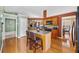 View of the kitchen featuring an island, wood cabinets, and hardwood floors at 407 Black Fox Dr, Locust Grove, GA 30248