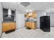 Basement kitchenette featuring wood cabinets, a black refrigerator, and neutral walls at 407 Black Fox Dr, Locust Grove, GA 30248