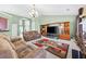 Spacious living room featuring a fireplace, vaulted ceilings, and ample natural light at 407 Black Fox Dr, Locust Grove, GA 30248