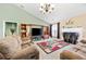 Bright living room with vaulted ceilings, a fireplace, and comfortable seating at 407 Black Fox Dr, Locust Grove, GA 30248