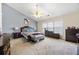 Spacious main bedroom features a vaulted ceiling, large window, and carpet floors at 407 Black Fox Dr, Locust Grove, GA 30248