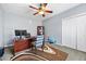 Bright home office with a modern desk, striped chair, and ample closet space at 407 Black Fox Dr, Locust Grove, GA 30248
