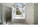 Bright bathroom featuring a soaking tub under an arched window and a glass enclosed shower at 12600 Silver Fox Court, Roswell, GA 30075