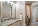 Bathroom featuring a vanity with a marble countertop and a shower with a decorative curtain at 12600 Silver Fox Court, Roswell, GA 30075