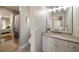 Bright bathroom with a marble vanity, a toilet, and a shower with a nature-themed curtain at 12600 Silver Fox Court, Roswell, GA 30075