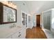 Spacious bathroom with double vanities, decorative mirrors, and a glass enclosed shower at 12600 Silver Fox Court, Roswell, GA 30075