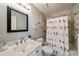 Cozy bathroom featuring tiled walls, a modern sink, and vanity with cabinet storage at 12600 Silver Fox Court, Roswell, GA 30075