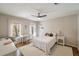 Cozy bedroom with natural light, ceiling fan, and neutral tones for a relaxing ambiance at 12600 Silver Fox Court, Roswell, GA 30075