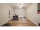 Bright exercise room featuring hard wood floors, ceiling fan, and workout equipment at 12600 Silver Fox Court, Roswell, GA 30075