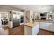 Gourmet kitchen with stainless appliances, a center island, and easy access to other living spaces at 12600 Silver Fox Court, Roswell, GA 30075