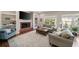 Cozy living room with a brick fireplace, built-in bookshelves, and comfortable seating at 12600 Silver Fox Court, Roswell, GA 30075