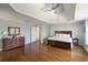 Large main bedroom with hardwood floors, tray ceilings, and neutral color scheme at 12600 Silver Fox Court, Roswell, GA 30075