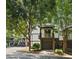 Inviting townhouse exterior with lush landscaping, a private balcony, and an attached garage at 215 Semel Nw Dr # 466, Atlanta, GA 30309