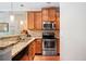 Well-equipped kitchen with stainless steel appliances, granite countertops, and wooden cabinets at 215 Semel Nw Dr # 466, Atlanta, GA 30309