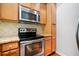 Stainless steel microwave and oven above light wood kitchen cabinets and granite countertops at 215 Semel Nw Dr # 466, Atlanta, GA 30309