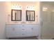 This elegant bathroom features a double vanity, framed mirrors, and a glass shower at 227 Atley Pl, Alpharetta, GA 30009