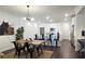 Elegant dining area with modern lighting fixture and open access to a gourmet kitchen at 227 Atley Pl, Alpharetta, GA 30009