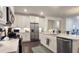 Gourmet kitchen with a central island, stainless steel appliances, and custom cabinetry at 227 Atley Pl, Alpharetta, GA 30009