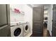 The laundry room features modern machines and convenient shelving for storage at 227 Atley Pl, Alpharetta, GA 30009