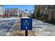 View of a residential street with sidewalks, a street sign, and well-maintained landscaping in a gated community at 227 Atley Pl, Alpharetta, GA 30009