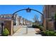 Street view of a charming neighborhood showcasing well-maintained homes and a decorative community entrance arch at 227 Atley Pl, Alpharetta, GA 30009
