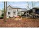 A spacious backyard offers a patio area with a fire pit, comfortable seating, and mature trees at 4057 Watkins Glen Dr, Woodstock, GA 30189