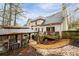 A home's backyard features a deck with an umbrella, and a gazebo with comfortable seating, perfect for outdoor living at 4057 Watkins Glen Dr, Woodstock, GA 30189