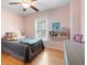 Bedroom with pink walls, and ceiling fan at 4057 Watkins Glen Dr, Woodstock, GA 30189