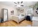 Bedroom with hardwood floors, ceiling fan, and window with natural light at 4057 Watkins Glen Dr, Woodstock, GA 30189