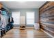 Walk-in closet with wood accent wall, shelves, and hardwood floors at 4057 Watkins Glen Dr, Woodstock, GA 30189