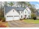 Charming two-story home featuring a two-car garage, well-maintained landscaping, and a welcoming entrance at 4057 Watkins Glen Dr, Woodstock, GA 30189
