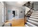 Inviting foyer with hardwood floors, a staircase with decorative iron railing, and an office view through glass doors at 4057 Watkins Glen Dr, Woodstock, GA 30189