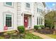 Close up of the front entry showing detailed landscaping, a stone walkway, and a bright red front door at 4057 Watkins Glen Dr, Woodstock, GA 30189