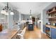 Spacious kitchen area with modern gray cabinetry and stainless steel appliances open to the eating area at 4057 Watkins Glen Dr, Woodstock, GA 30189