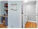 Transition space with wine fridge and shelving, leading to laundry room with modern washer and dryer at 4057 Watkins Glen Dr, Woodstock, GA 30189