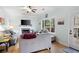 Cozy living room featuring a fireplace, a ceiling fan, and a door leading to the back porch at 4057 Watkins Glen Dr, Woodstock, GA 30189