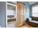 Main bathroom featuring a tub with stone surround and barn door access at 4057 Watkins Glen Dr, Woodstock, GA 30189
