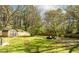 Expansive backyard featuring a storage shed, patio with seating, and plenty of room for recreation at 576 Quillian Ave, Decatur, GA 30032