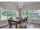 Inviting dining room with ample natural light, hardwood floors, and contemporary chandelier for elegant meals at 576 Quillian Ave, Decatur, GA 30032