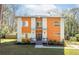 Contemporary two-story home with unique orange and white design, featuring a welcoming entrance and well-kept lawn at 576 Quillian Ave, Decatur, GA 30032