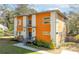 Modern two-story home featuring a unique orange and white exterior, complemented by well-maintained landscaping and large windows at 576 Quillian Ave, Decatur, GA 30032