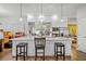 Open kitchen with a large island, modern white cabinets, stainless steel appliances, and pendant lighting at 576 Quillian Ave, Decatur, GA 30032